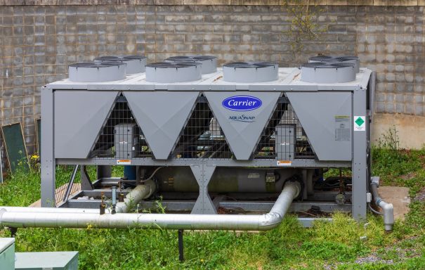 Carrier Chillers Picture of a single carrier chiller located outside of a building at ground level