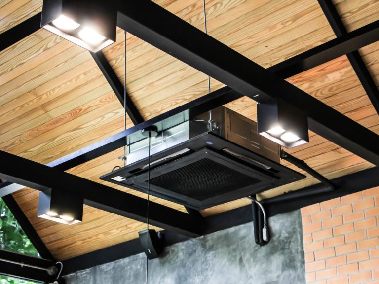 Professional Design Service Exposed air conditioning cassette installation in black matching visible structral roof beams